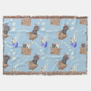 Cats in box and milk drops on blue throw blanket