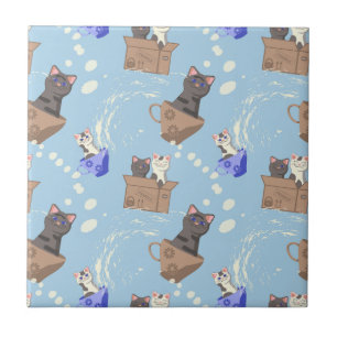 Cats in box and milk drops on blue tile