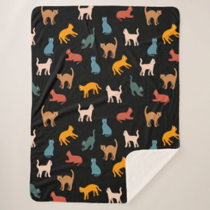 Cats on the black sherpa blanket