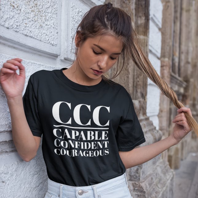 CCC- Capable, Confident, Courageous T-Shirt (Young woman wears a "CCC:Capable, Confident, Courageous" black t-shirt.)