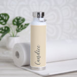 Champagne Personalised Wedding Bridesmaid Water Bottle<br><div class="desc">Gift your wedding bridesmaid or maid of honour with this trendy, vacuum Insulated water bottle that features her name in grey, stylised script on a champagne colour background designed to match your wedding colour scheme. Personalise bottle by editing and replacing name with your own as desired. Select your water bottle...</div>