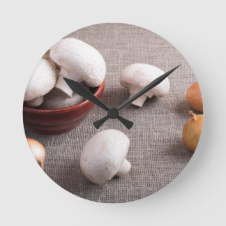 Champignon mushrooms and onions on the table round clock