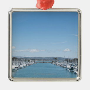 channel in harbour on a sunny day with blue sky metal tree decoration