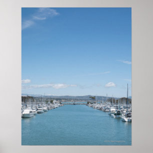 channel in harbour on a sunny day with blue sky poster