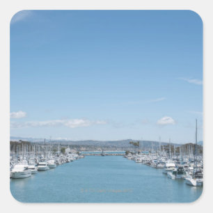 channel in harbour on a sunny day with blue sky square sticker