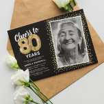 Cheers to Eighty Years 80th Birthday Photo Invitation<br><div class="desc">Celebrate the grand milestone of turning eighty with our elegant birthday party invitations. With a customisable trendy black background, a personal photo spot, and golden accents, these invitations are sure to leave a lasting impression. The gold helium balloon details add a touch of magic, while the modern 80th birthday text...</div>