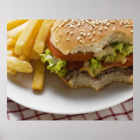 Cheeseburger, bites taken, with chips