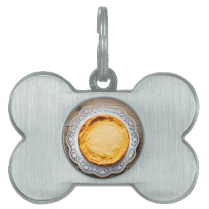 Cheesecake on rustic wood cake top. pet ID tag