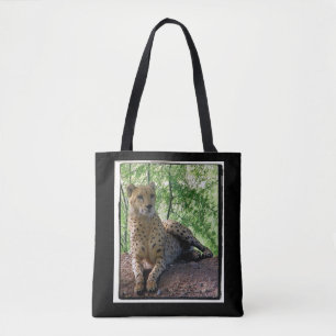 Cheetah on a rock tote bag