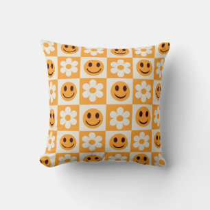 Chequered white flowers and orange smiling faces cushion