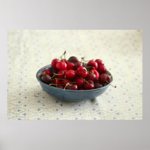 Cherries in a blue bowl poster