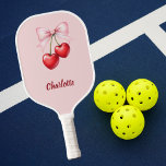 Cherry bow pink name pickleball paddle<br><div class="desc">Red cherries with pink bow. Soft pink background. Personalise and add your name.</div>