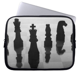 Chess pieces on chess board in black and white laptop sleeve