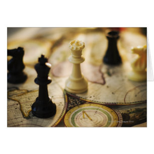 Chess pieces on old world map