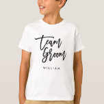 Chic Trendy Brush Black Script Team Groom T-Shirt<br><div class="desc">T-shirt featuring the words "Team Groom" in chic trendy brush black script that's perfect for the ring bearer. For other matching items see here https://www.zazzle.com/collections/119250194970828530?rf=238364477188679314 Personalise it by replacing the placeholder text. For more options such as to change the font and it's size, colour or the spacing between letters click...</div>