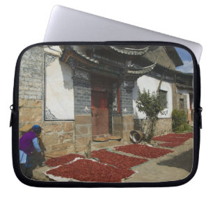 CHINA, Yunnan Province, Tianshengying. Drying Laptop Sleeve