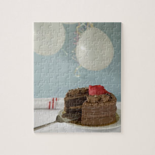 Chocolate cake with missing slice on table, jigsaw puzzle