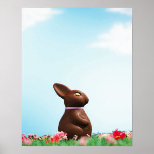 Chocolate Easter bunny amongst flowers in grass, Poster