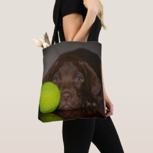Chocolate Labrador Puppy With Tennis Ball Tote Bag