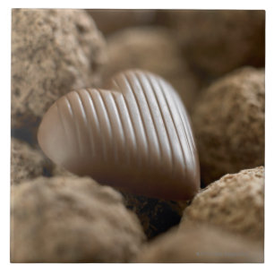 chocolate nestled amongst other chocolates tile