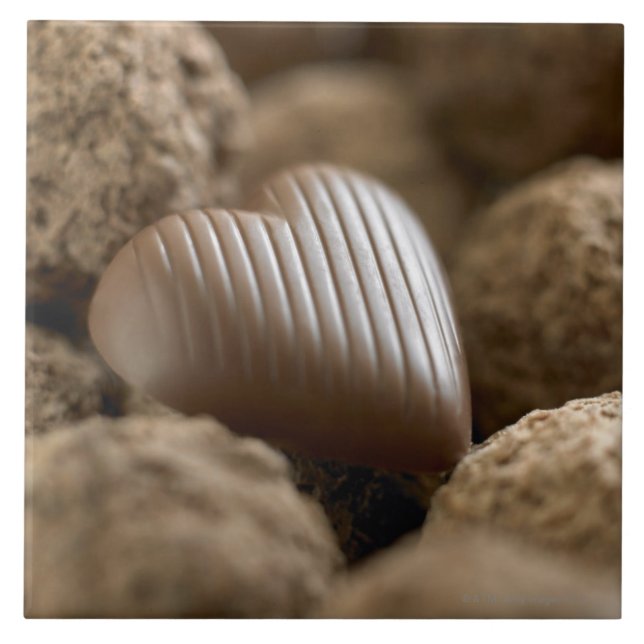 chocolate nestled amongst other chocolates tile (Front)