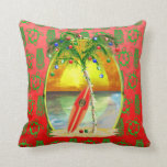 Christmas Beach Sunset Cushion<br><div class="desc">Happy Holidays from the warm sandy beaches of your favourite tropical island beach. Palm tree decorated with Christmas ornaments and lights, with a retro surfboard leaning against the Christmas tree in front a sunset over the ocean. Red and green holiday colour background of Hawaiian Honu sea turtles and Tiki Masks...</div>