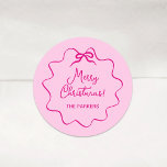 Christmas Bow | Whimsical Wavy Pink Classic Round Sticker<br><div class="desc">These adorable coquette holiday stickers feature a trendy,  bright pink wavy frame with a whimsical retro ribbon bow,  on a chic blush pink background. Modern script says "Merry Christmas."</div>