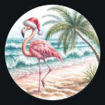 Christmas Flamingo On a Beach Classic Round Sticker<br><div class="desc">A flamingo wearing a Santa hat strolls along a sandy beach with waves gently crashing nearby</div>