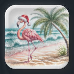 Christmas Flamingo On a Beach Paper Plate<br><div class="desc">A flamingo wearing a Santa hat strolls along a sandy beach with waves gently crashing nearby</div>