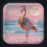 Christmas Flamingo On Pink Beach Paper Plate<br><div class="desc">A flamingo stands on a beach adorned with a Christmas wreath and a Santa hat set against the backdrop of a pink full moon and a colourful sunset</div>