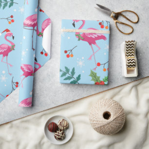 Christmas flamingos and holly on blue pattern wrapping paper