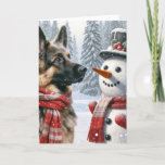 Christmas German Shepherd With Snowman Card<br><div class="desc">A German Shepherd wearing a red and white scarf stands beside a snowman and a top hat amidst a snowy landscape
Text can be changed.</div>