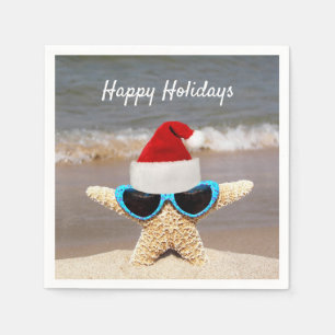 Christmas hat on tropical starfish on beach napkin