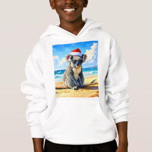 Christmas Koala santa hat on the sunny sandy beach