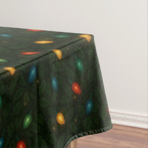 Christmas lights wrapped in holly leaves patterned tablecloth