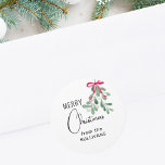 Christmas Mistletoe  Classic Round Sticker<br><div class="desc">This festive sticker is decorated with green watercolor mistletoe,  a red ribbon,  and stylish script typography. 
Easily Customisable.
Original Watercolor © Michele Davies.</div>