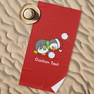 Christmas penguin getting a snow ball beach towel