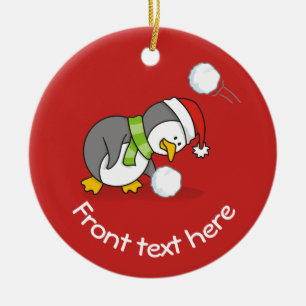 Christmas penguin getting a snow ball ceramic tree decoration