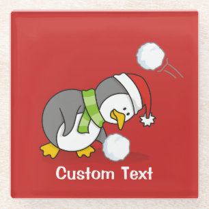 Christmas penguin getting a snow ball glass coaster