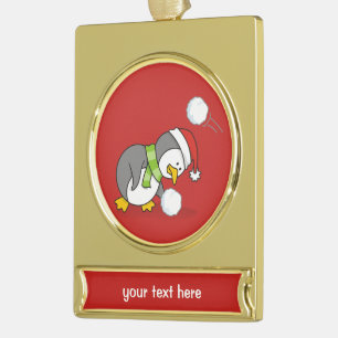 Christmas penguin getting a snow ball gold plated banner ornament