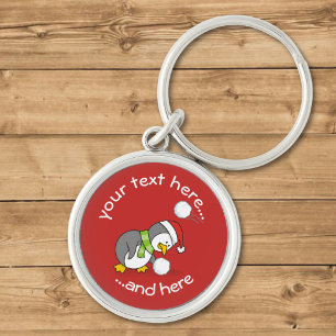 Christmas penguin getting a snow ball key ring
