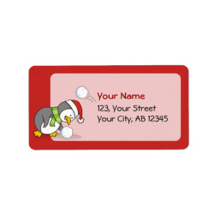 Christmas penguin getting a snow ball label