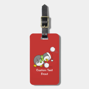 Christmas penguin getting a snow ball luggage tag