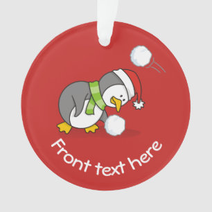 Christmas penguin getting a snow ball ornament