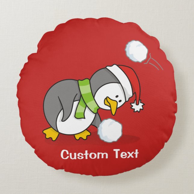 Christmas penguin getting a snow ball round cushion (Front)