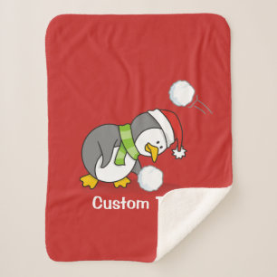 Christmas penguin getting a snow ball sherpa blanket