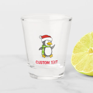 Christmas penguin walking on snow shot glass