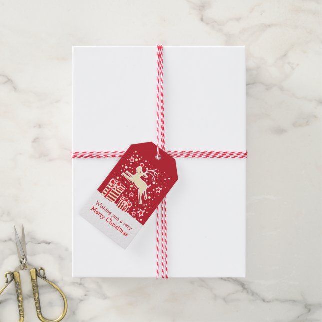 Christmas reindeer prancing over gifts red tag (With Twine)