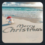 Christmas Sand Man On a Beach Square Sticker<br><div class="desc">A small sand snowman wearing a Santa hat stands on an ocean beach with "Merry Christmas" written in the sand</div>