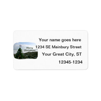 Christmas Tree Against Beach Rocks Merry Christmas Label